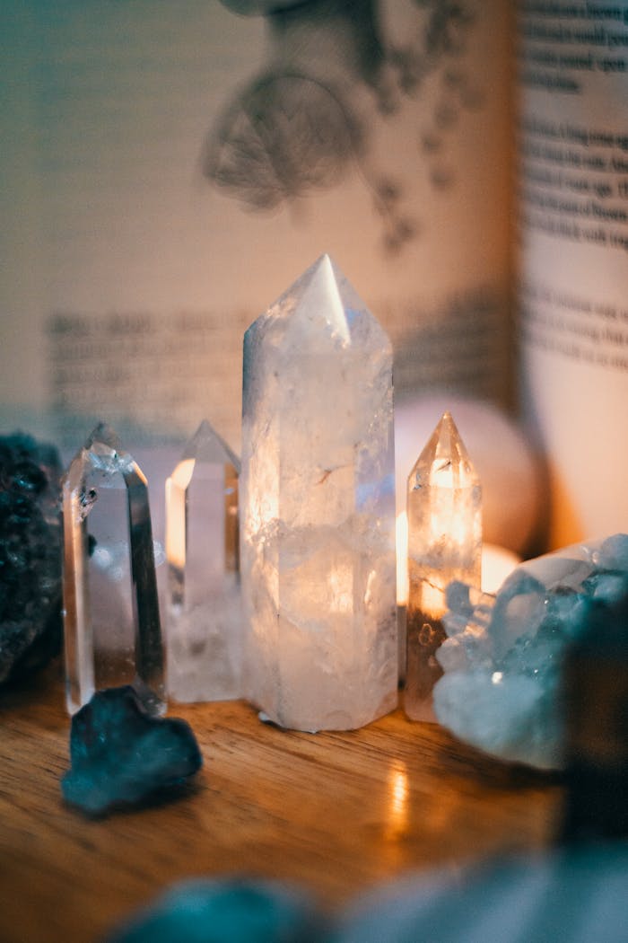 services-03 Beautiful quartz crystals displayed on a wooden table with warm ambient lighting.